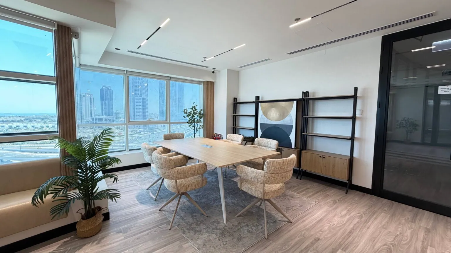 The Privé Lounge common area arranged with a long table and chairs for events and workshops